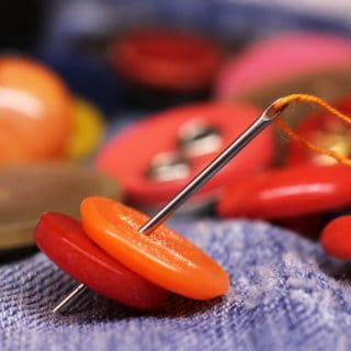 How to Sew a Button on Pants